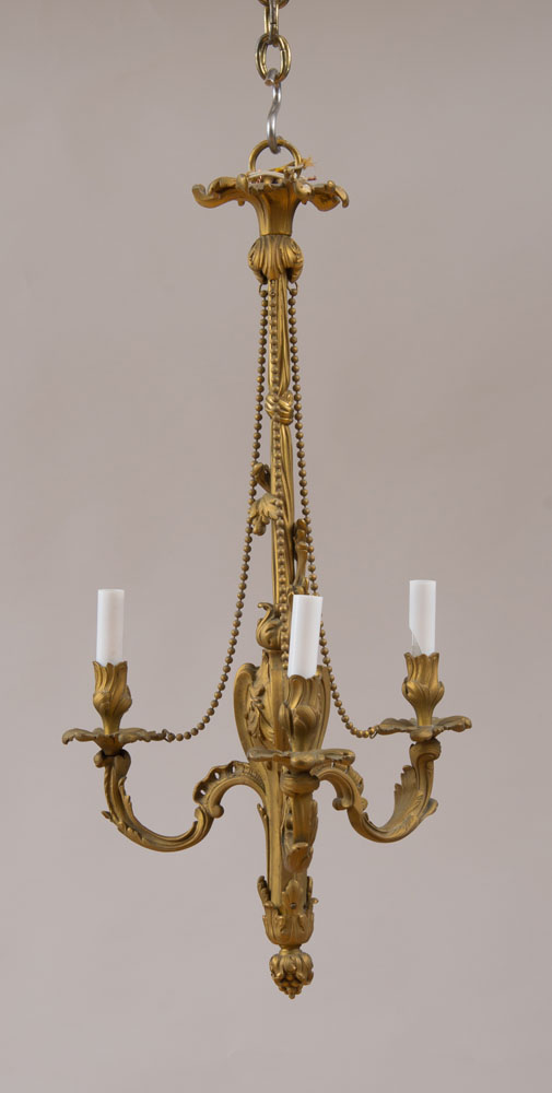 Appraisal: LOUIS XV STYLE GILT-BRONZE THREE-LIGHT CHANDELIER The foliate-cast urn supporting