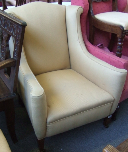 Appraisal: A th century mahogany framed wing armchair with outswept crest