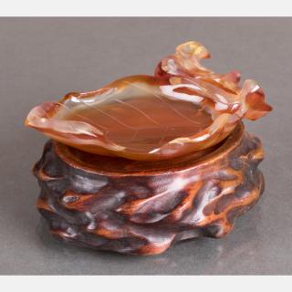 Appraisal: A Chinese Carved Agate Leaf Form Washer on a Carved