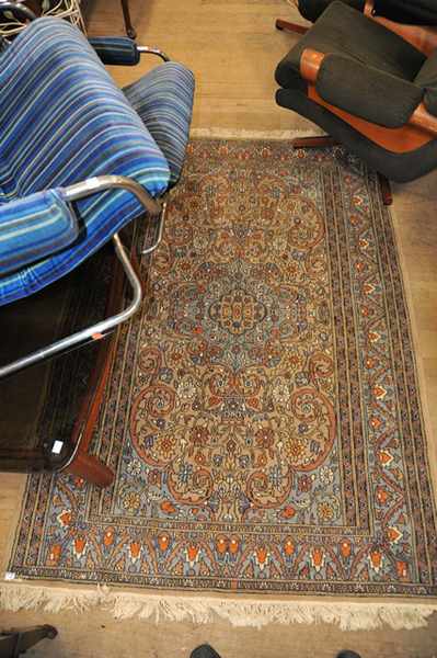 Appraisal: A PERSIAN RUG IN PURPLE AND BROWN TONES