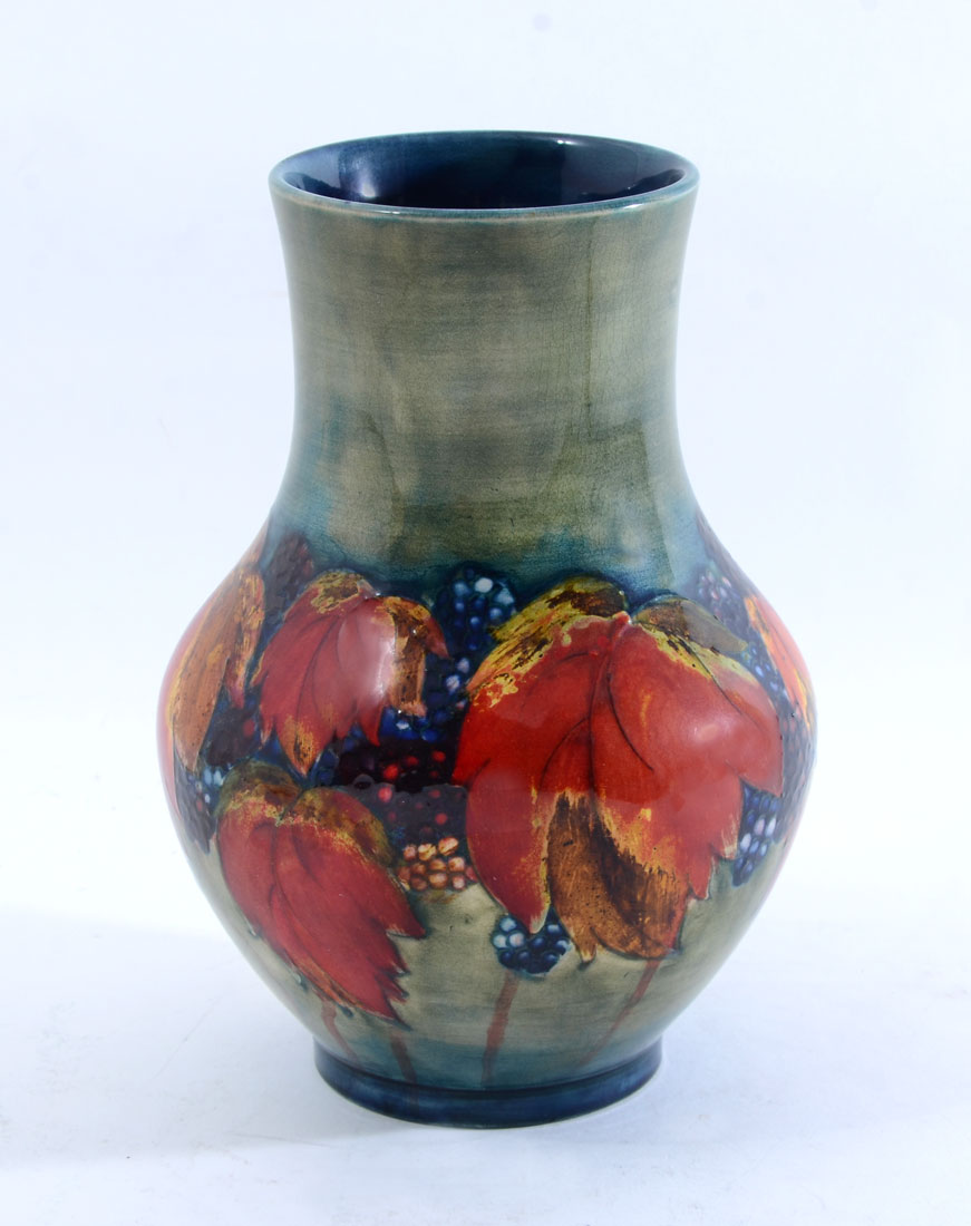 Appraisal: MOORCROFT POTTERY GRAPES AND VINE VASE Mottled green ground with