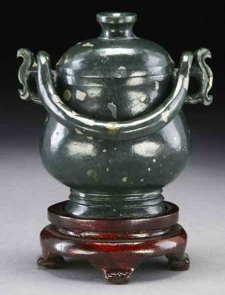 Appraisal: Chinese carved silver splashed celadon jade urn with a free