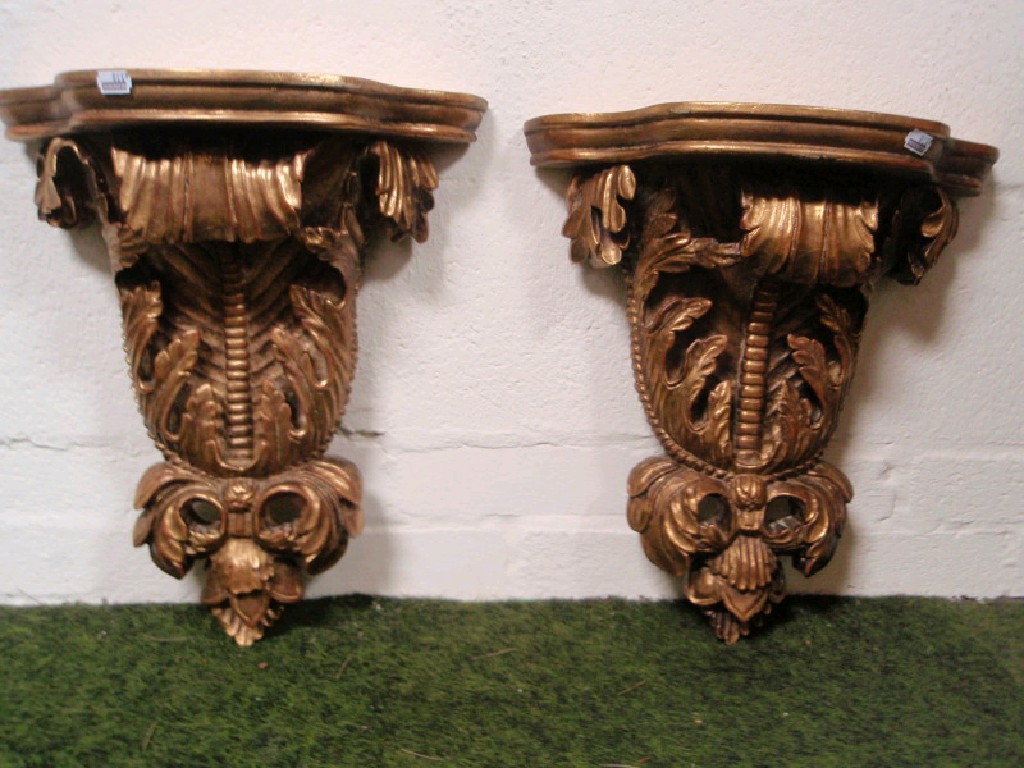 Appraisal: A pair of gilt-wood scroll wall brackets cm high