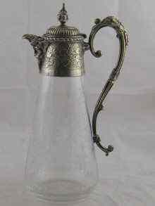 Appraisal: A glass claret jug with silver plated mounts the glass