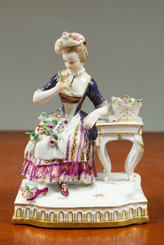 Appraisal: MEISSEN PORCELAIN FIGURINE of a young woman seated at a