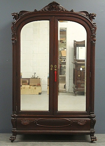 Appraisal: - Empire mahogany armoire with mirrored doors carved winged leopards