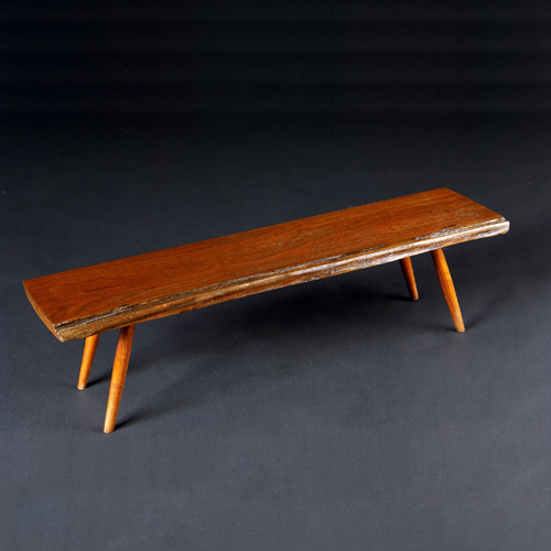 Appraisal: GEORGE NAKASHIMA Walnut small coffee table with legs mortised through