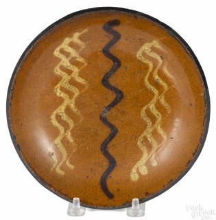 Appraisal: Pennsylvania redware pie plate th c with yellow and brown