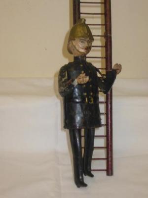 Appraisal: A French ladder climbing fireman clockwork operated marked F M