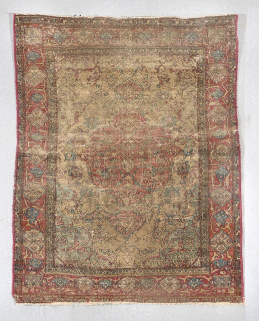 Appraisal: AN OLD PERSIAN RUG with central red ground medallion and