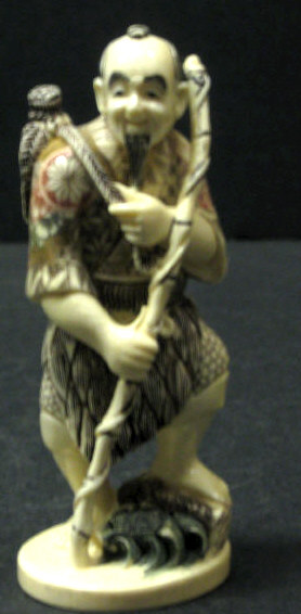 Appraisal: JAPANESE CARVED IVORY STANDING FIGURE A man with staff etched