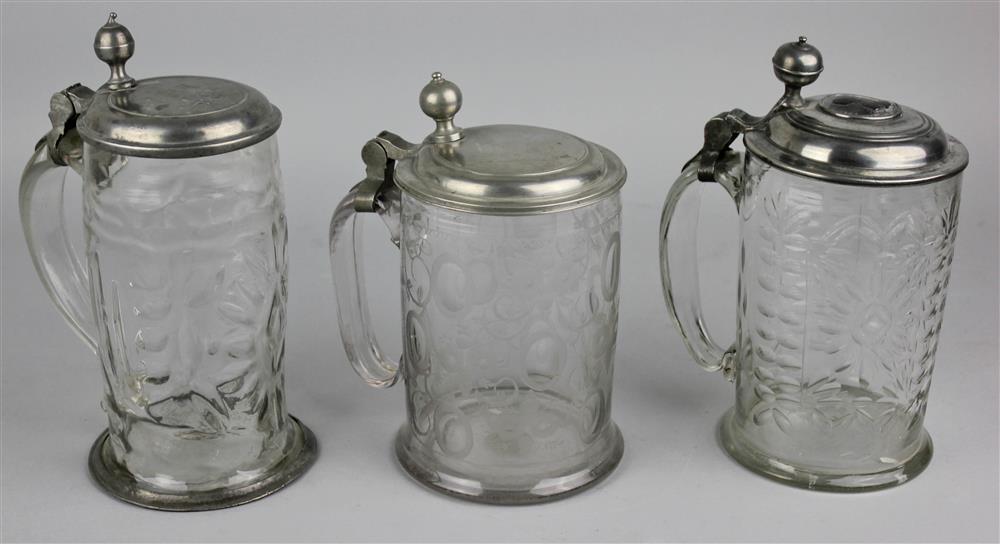 Appraisal: THREE GERMAN PEWTER MOUNTED GLASS STEINS th th Century the