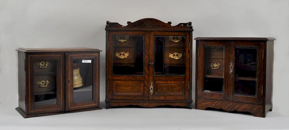 Appraisal: Three English Victorian Oak Tobacco Cabinets with bevelled glass doors