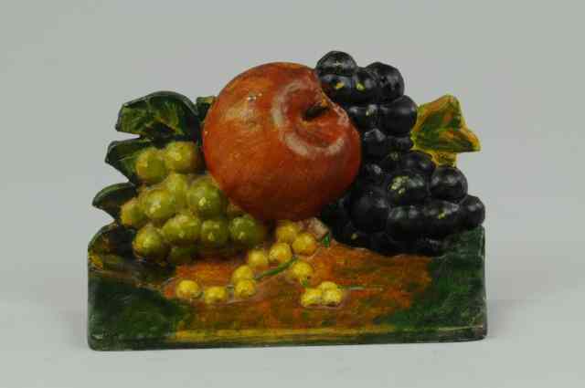 Appraisal: APPLE AND GRAPES DOORSTOP Charming presentation of amber apple surrounded