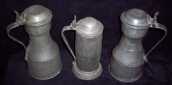 Appraisal: A pair of lidded pewter tankards of waisted form each