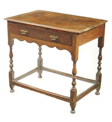 Appraisal: An oak side table with a moulded edge top with