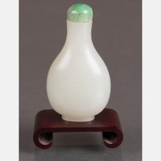 Appraisal: A White Jade Snuff Bottle with Green Jade Stopper on