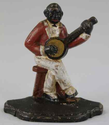 Appraisal: BLACK BANJO PLAYER DOORSTOP Spencer cast iron figure of seated