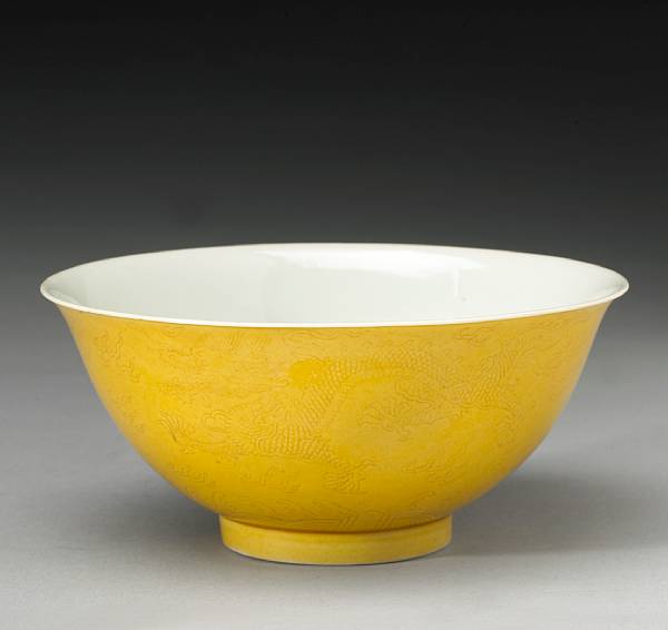 Appraisal: A yellow glazed porcelain bowl with incised dragon decoration Jiaqing