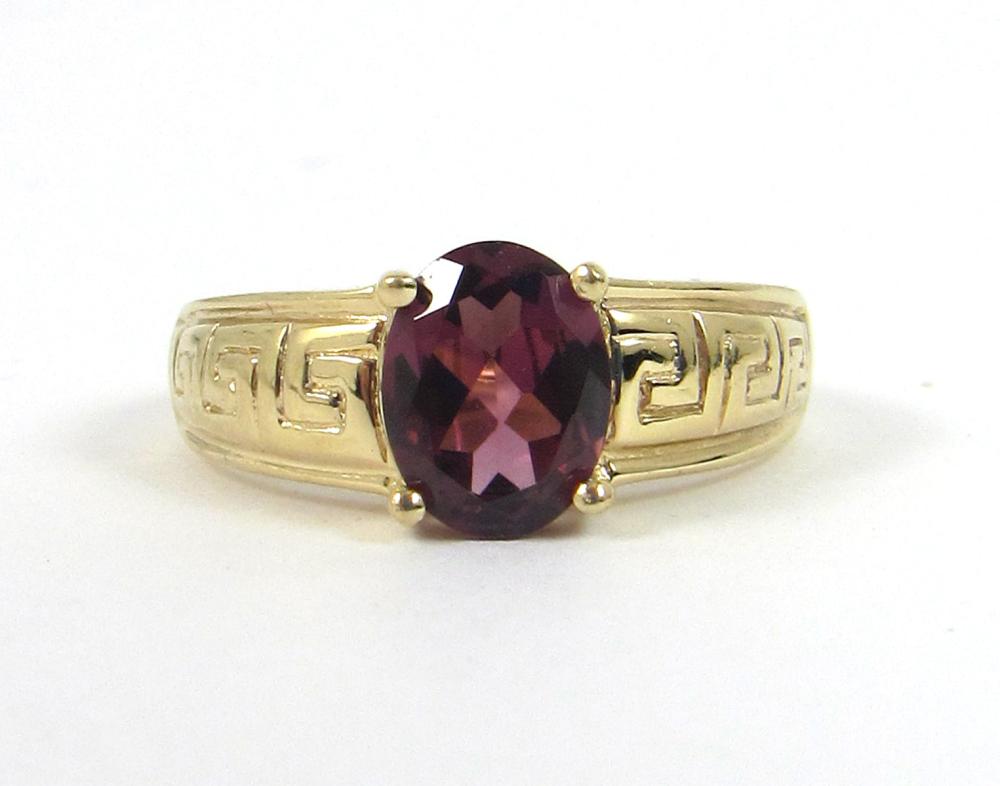 Appraisal: GARNET AND FOURTEEN KARAT GOLD SOLITAIRE RING with four yellow