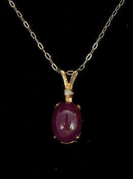 Appraisal: A k Gold Pendant Set with Star Ruby and a