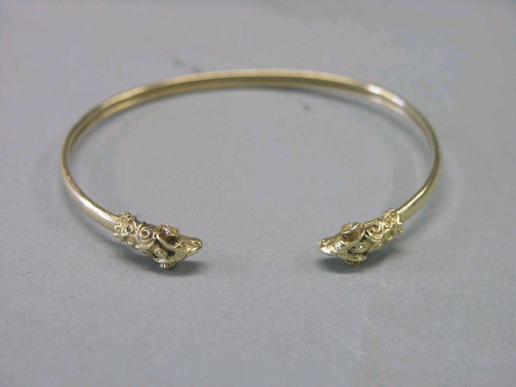 Appraisal: A ct gold bangle with ram's head terminals grams SEE