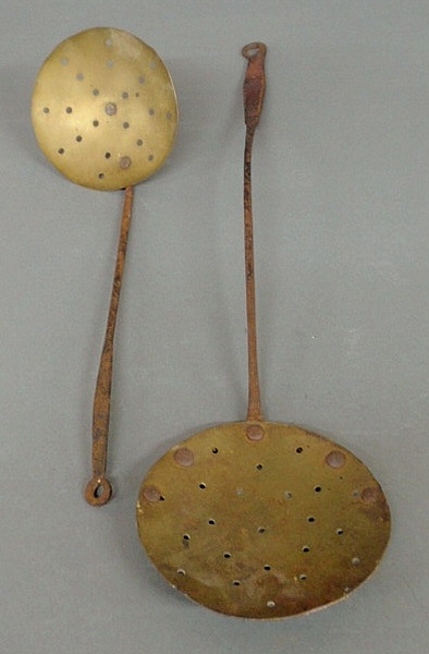 Appraisal: Two brass and wrought iron strainers th c l and