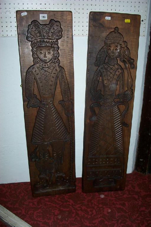 Appraisal: A pair of tall continental carved wooden panel moulds representing