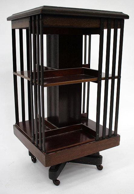 Appraisal: AN EDWARDIAN MAHOGANY ROTATING BOOKCASE the square top cm wide