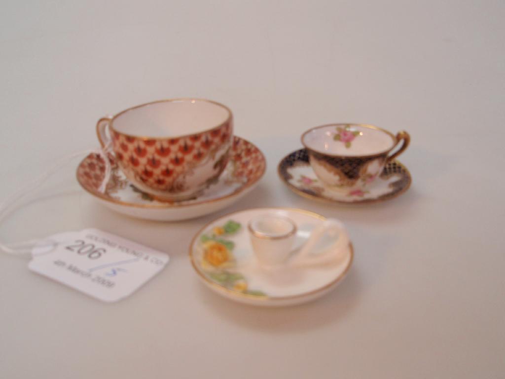 Appraisal: A thC German porcelain miniature tea cup and saucer painted