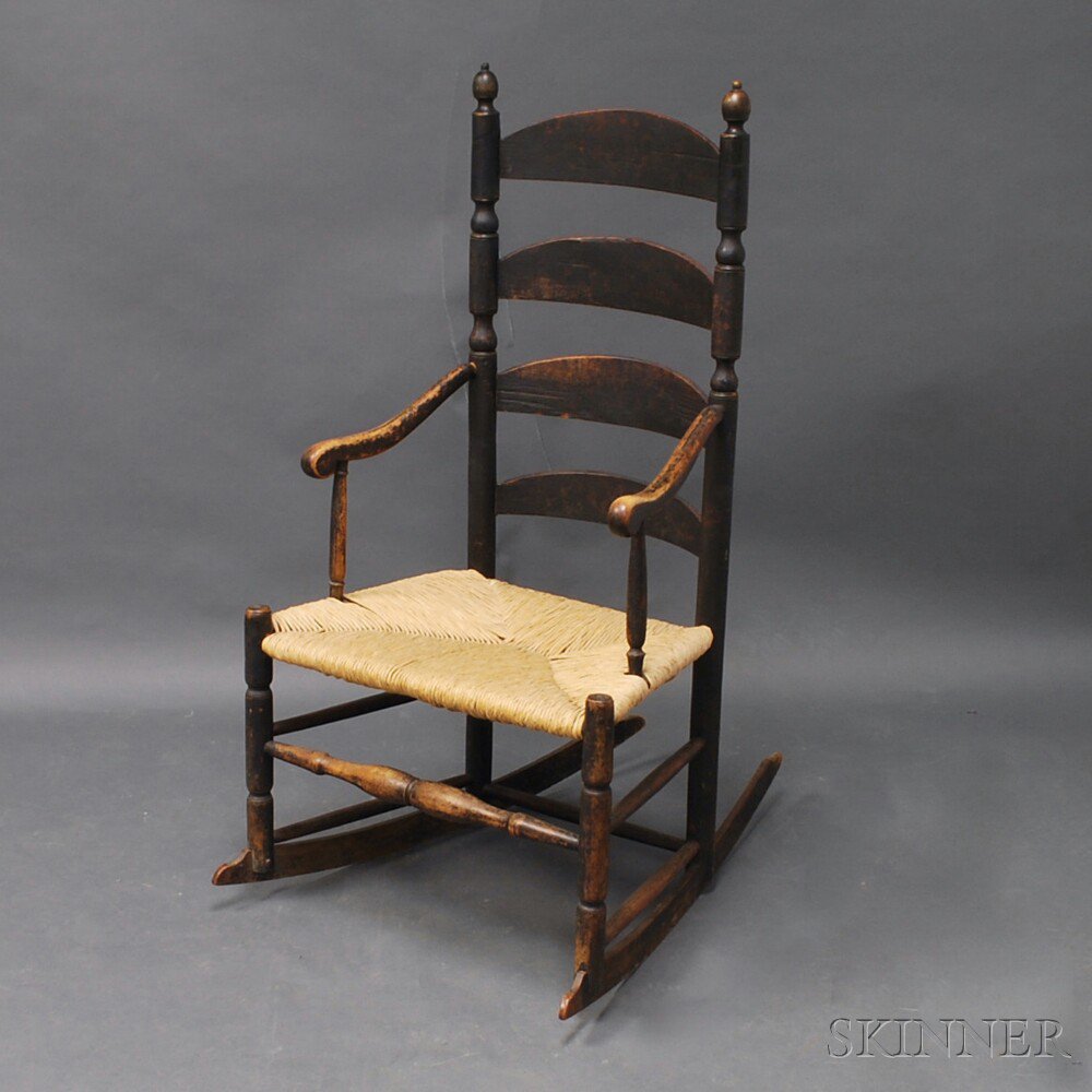 Appraisal: Black-painted Slat-back Armrocker America th th century the baluster- and