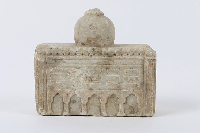 Appraisal: AN INDIAN ISLAMIC MARBLE FRAGMENTARY CARVING of a mosque with