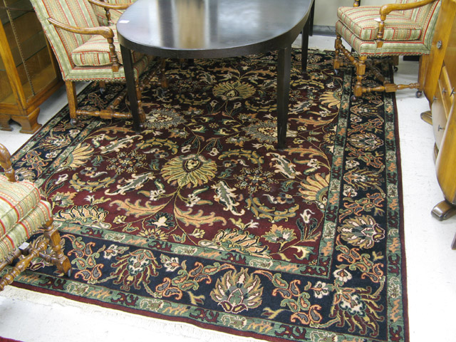 Appraisal: HAND KNOTTED ORIENTAL CARPET Indo-Persian overall floral decorated burgundy ground