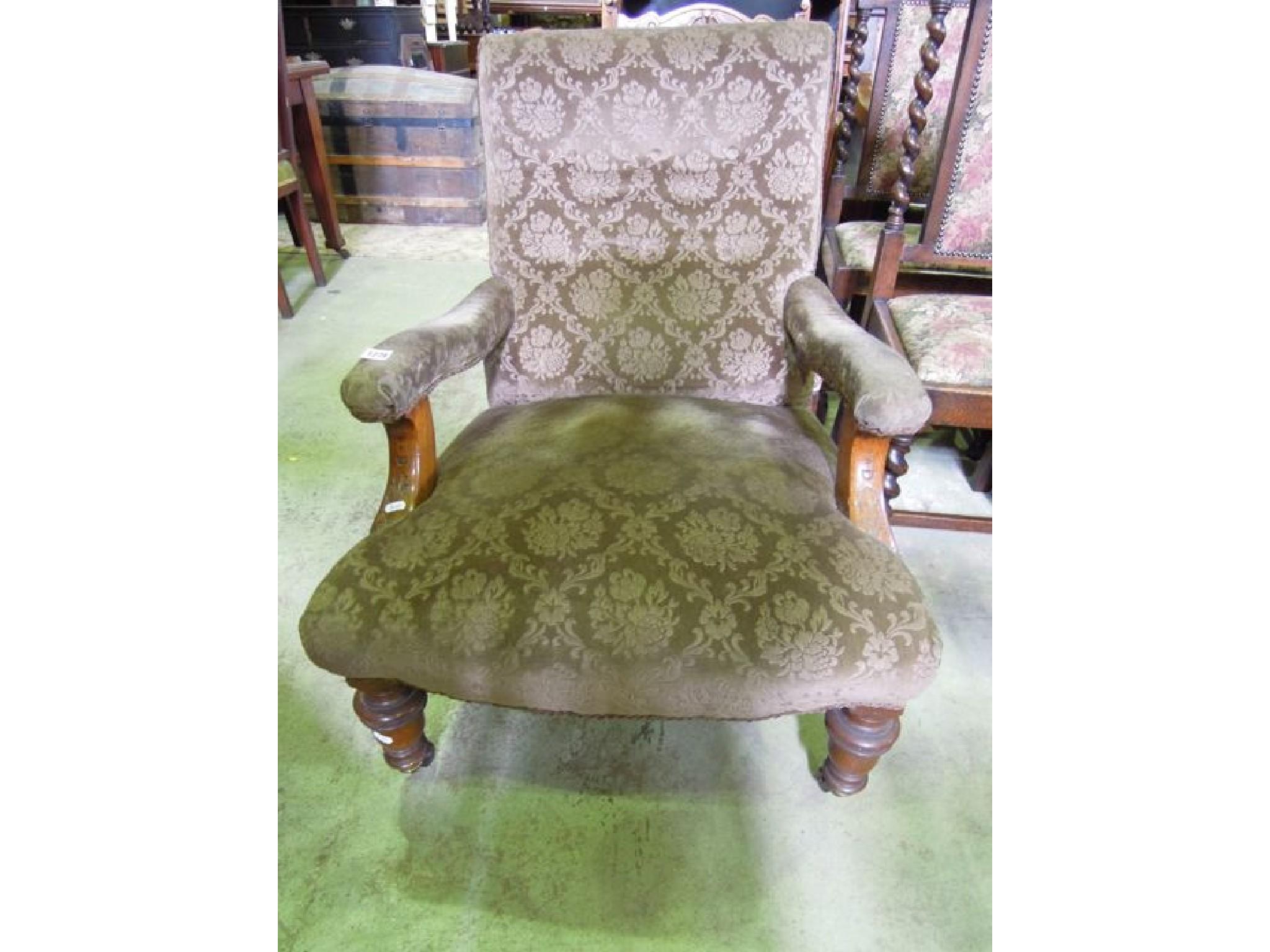 Appraisal: A Victorian open armchair with shaped outline upholstered finish raised