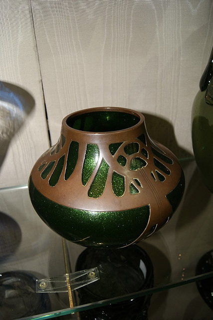 Appraisal: A SECESSIONIST GREEN GLASS VASE probably Austrian with copper casing