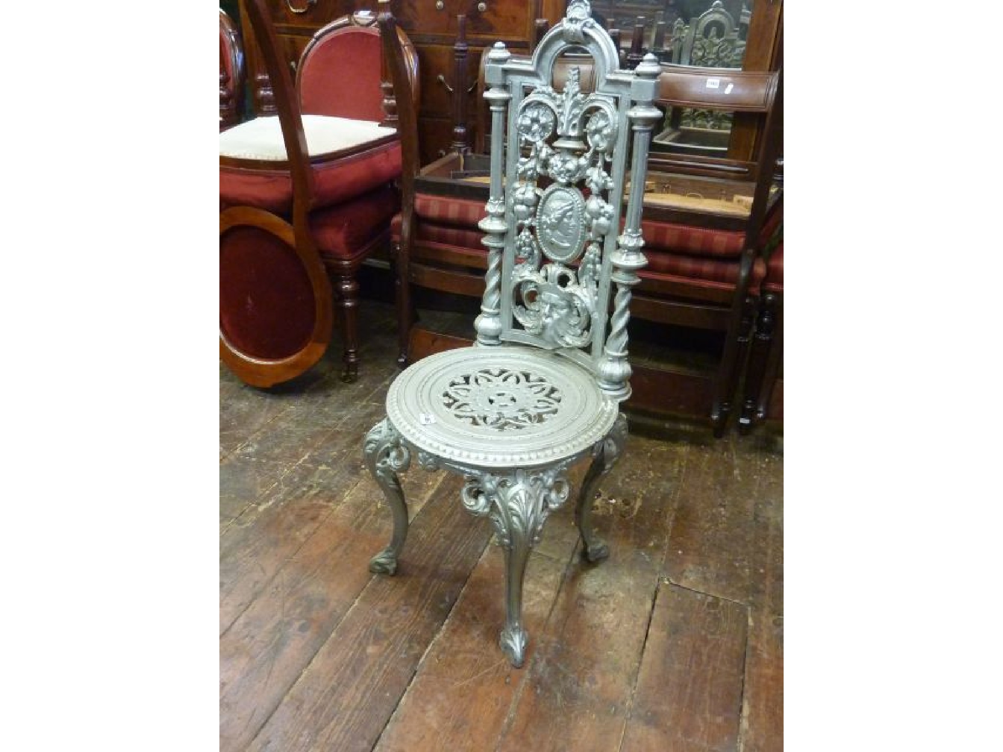 Appraisal: A mid Victorian cast iron single chair the circular pierced