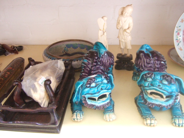 Appraisal: A pair of Chinese models of lion dogs each modelled