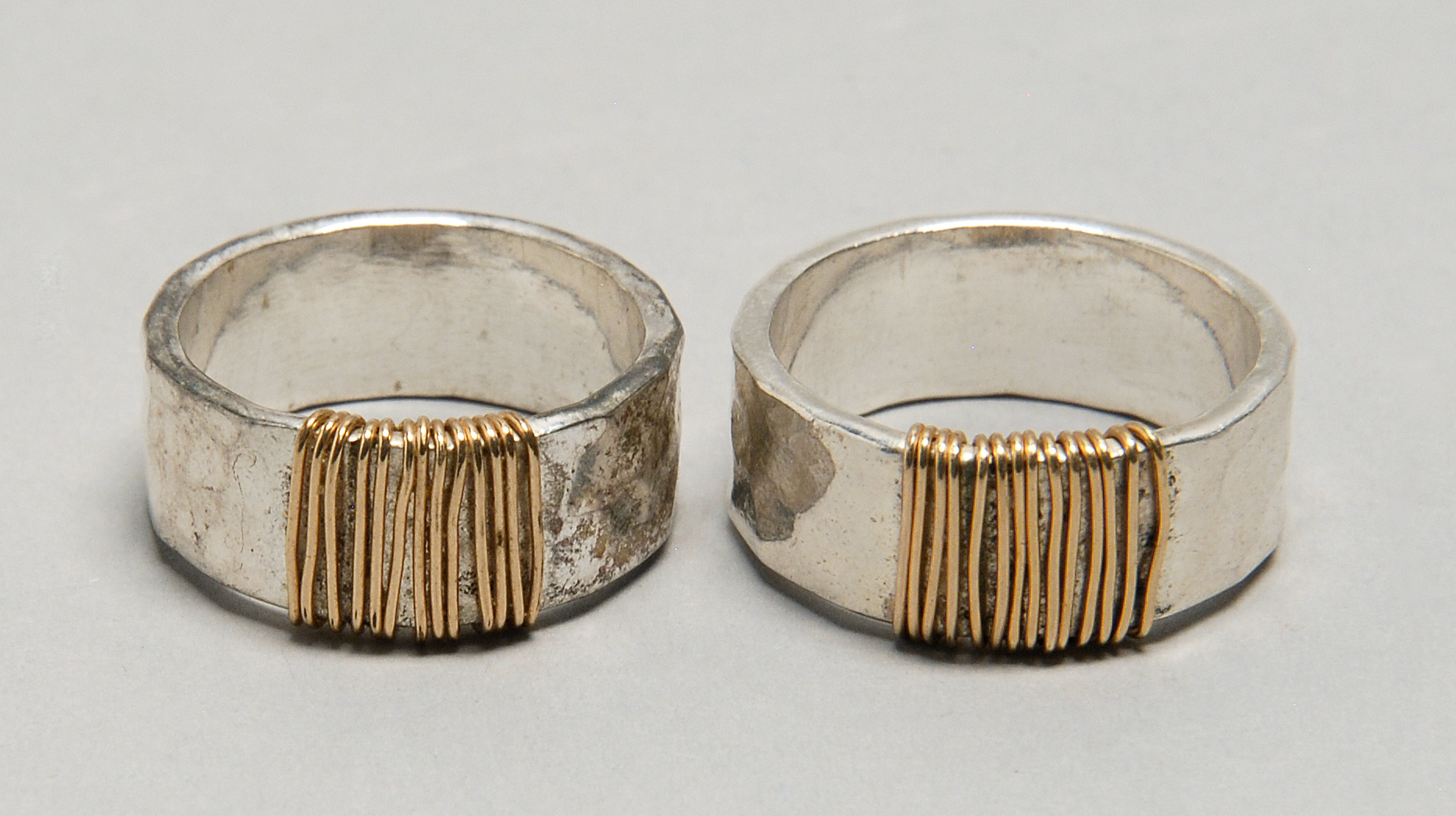 Appraisal: TWO HAND-HAMMERED STERLING SILVER RINGS Wrapped with kt gold wire