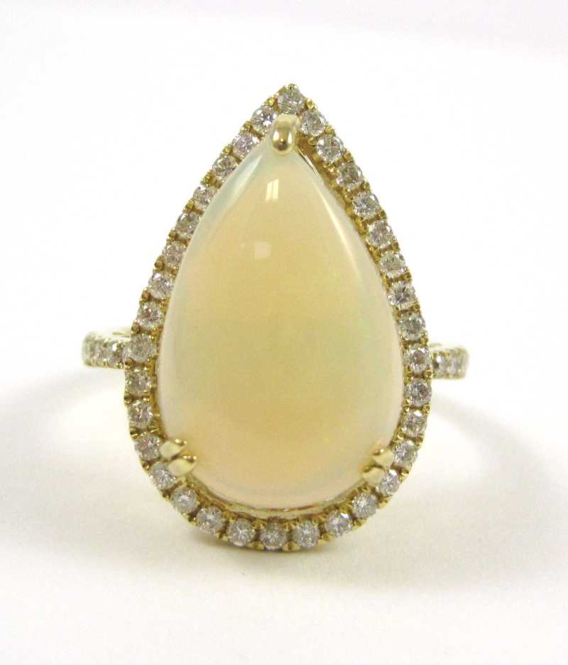 Appraisal: WHITE OPAL AND DIAMOND KARAT YELLOW GOLD RING the pear