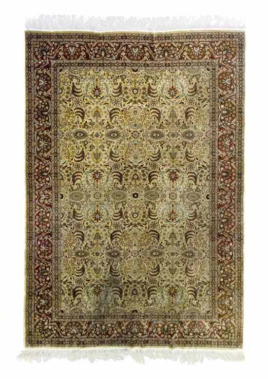 Appraisal: A Persian Silk and Wool Carpet having a foliate center