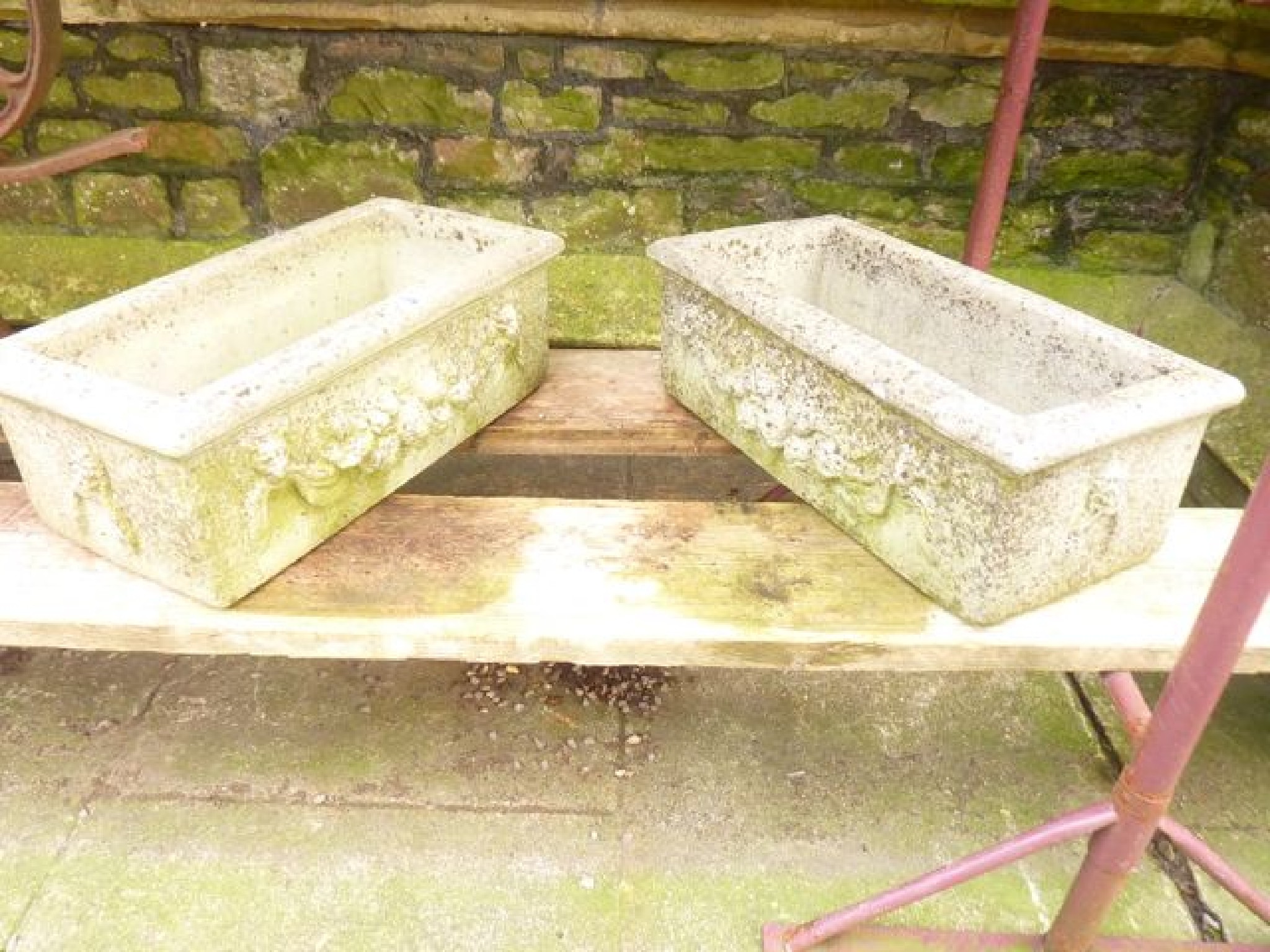 Appraisal: A pair of reconstituted garden planters together with a garden