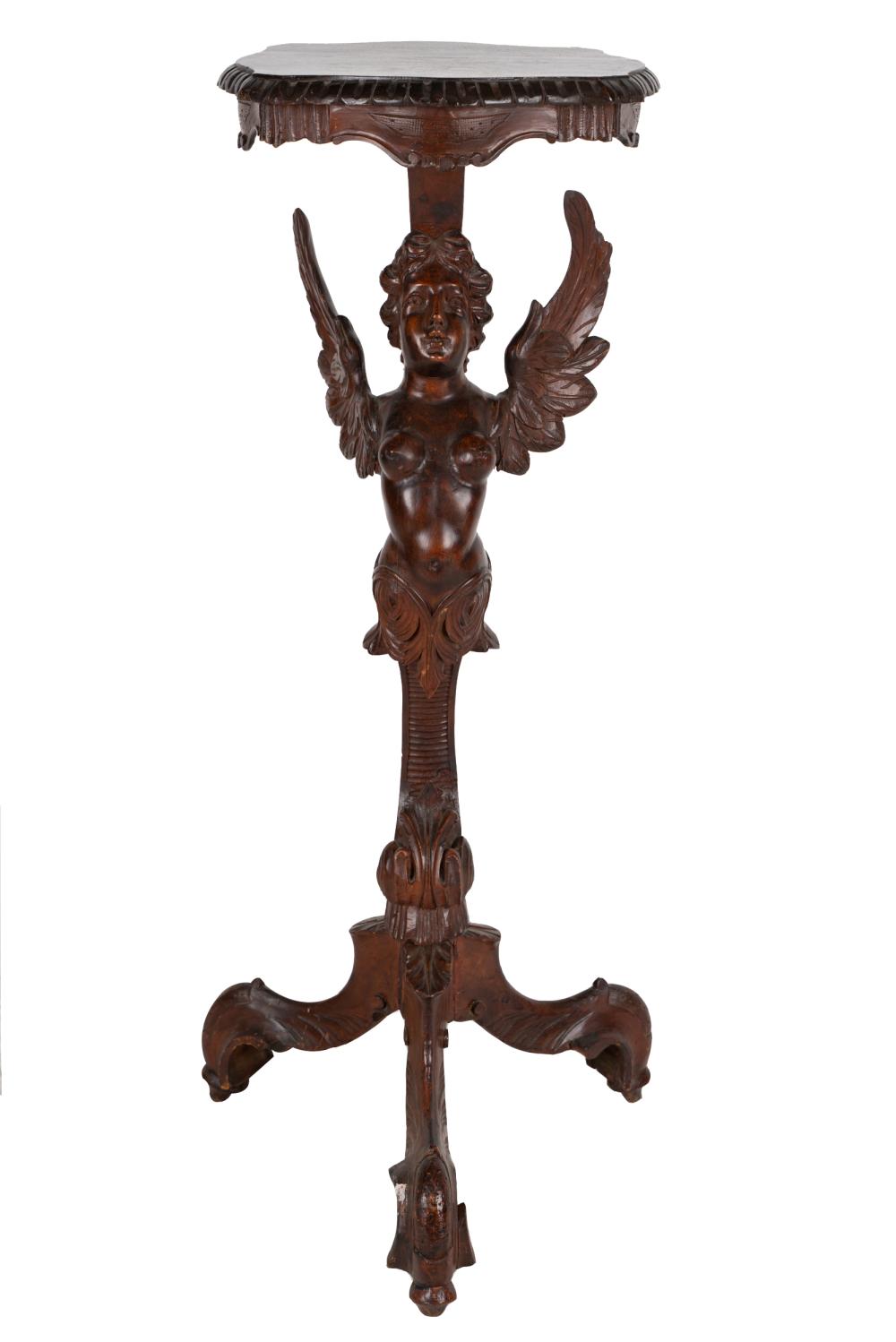 Appraisal: CARVED WALNUT FIGURAL PEDESTALon a tripod base Condition with a