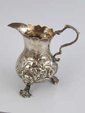 Appraisal: A Georgian silver cream jug with original embossing and rococo