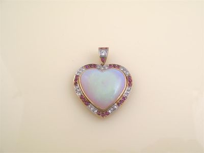 Appraisal: A large heart shaped opal pendant Within a gold frame