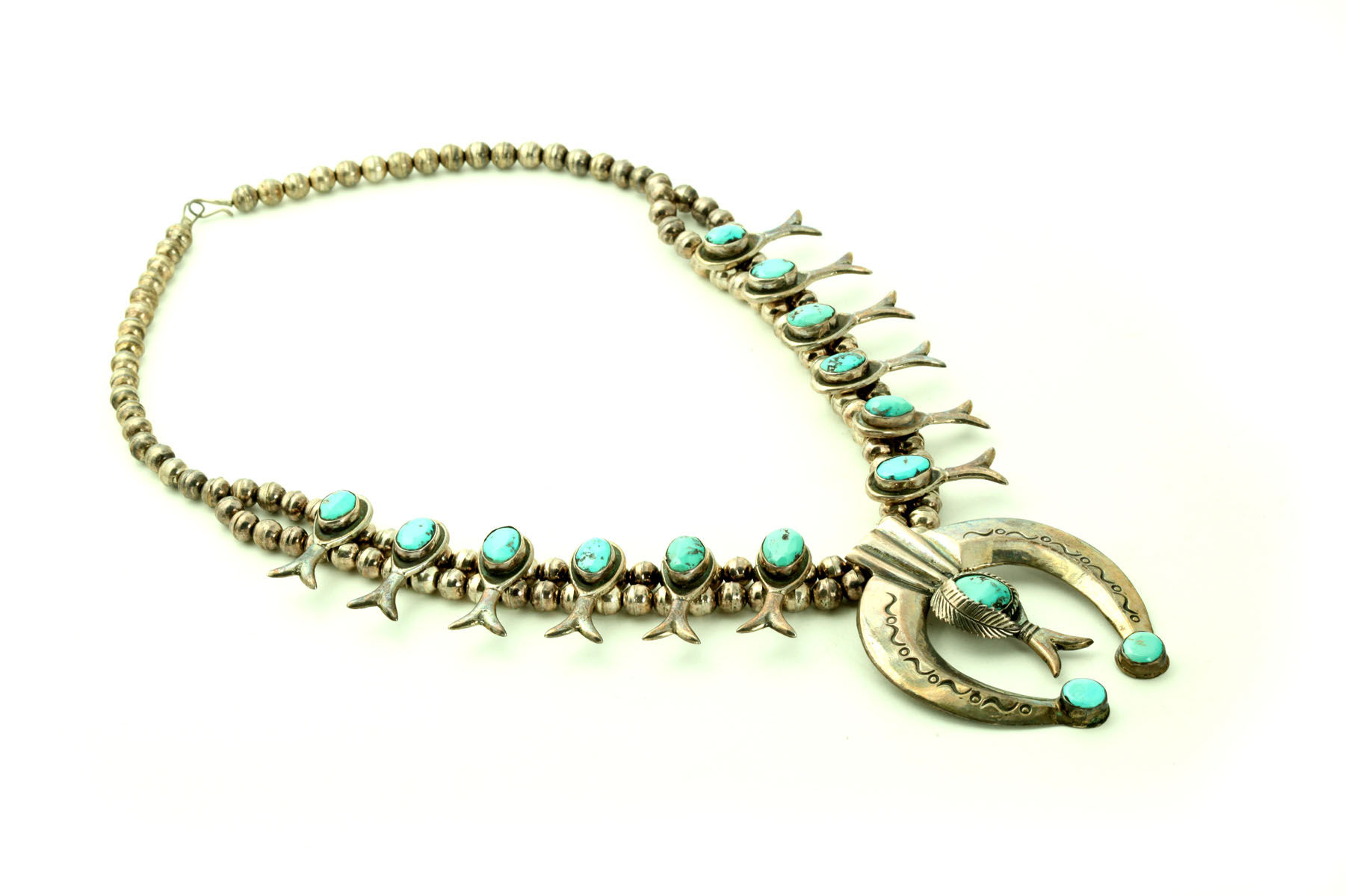 Appraisal: SQUASH BLOSSOM NECKLACE Twentieth century Set with turquoise ''l overall