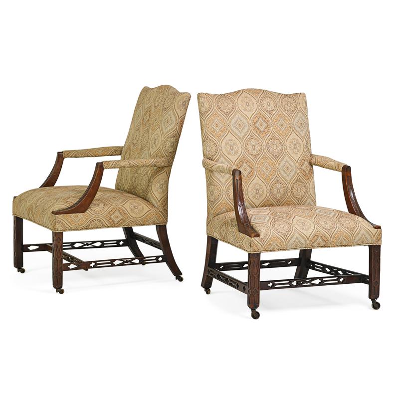 Appraisal: PAIR OF GEORGE III STYLE LIBRARY ARMCHAIRS Mahogany carved frames