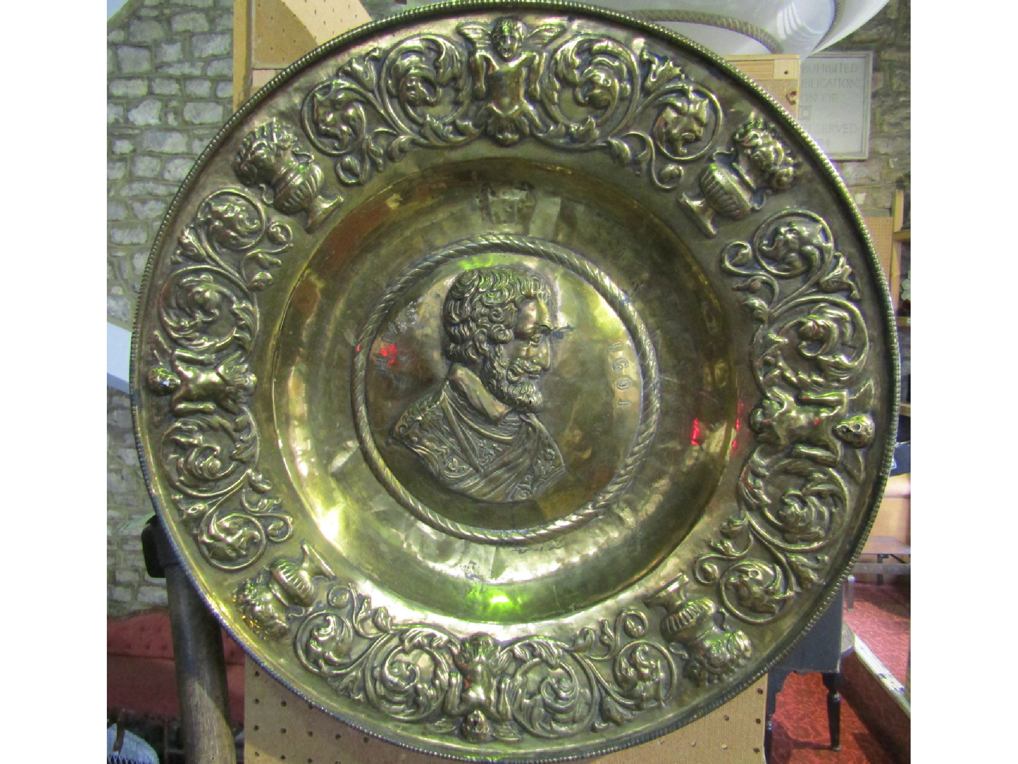 Appraisal: A substantial brass alms dish the central detail with a