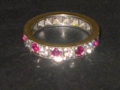 Appraisal: A DIAMOND AND RUBY HALF ETERNITY RING the brilliant cut