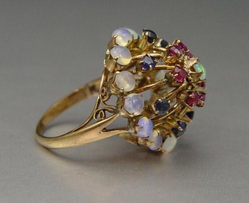 Appraisal: K HAREM RING WITH OPALS RUBIES AND SAPPHIRES K yellow