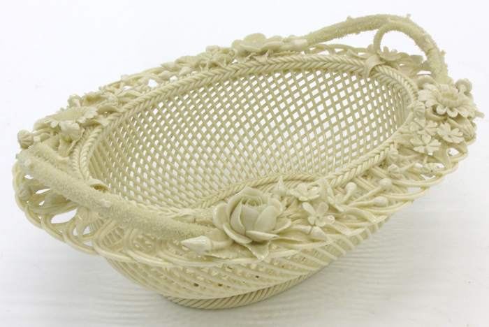 Appraisal: IRISH BELLEEK OVAL FOUR STRAND BASKET floral decorated rim twig